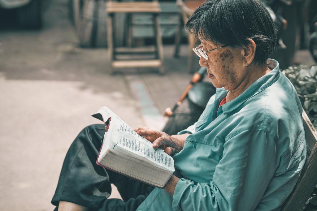 An elderly person reading.