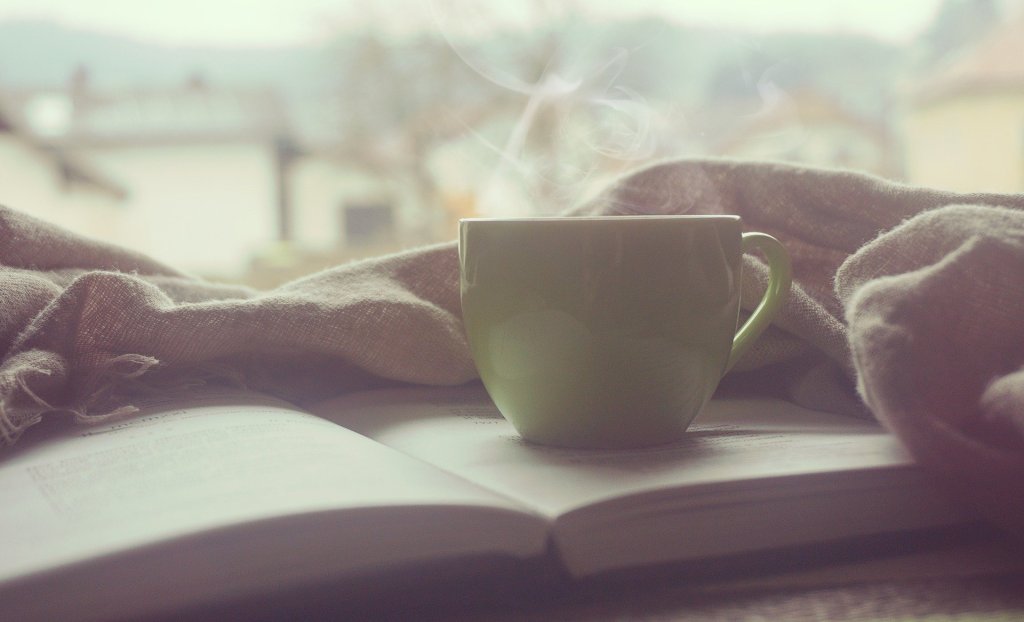 A warm cup of tea on top of a book.