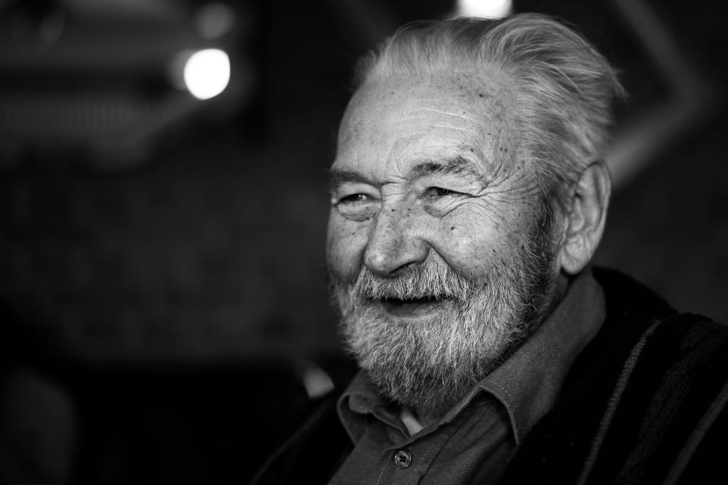 An elderly man smiling.