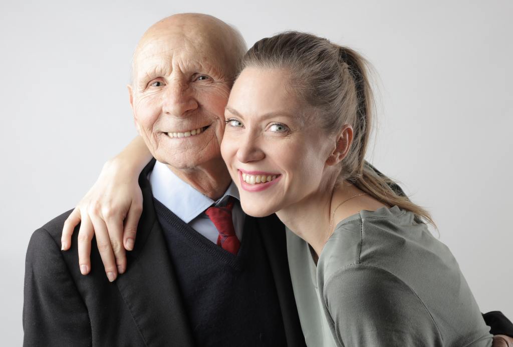 An elderly father and his daughter.